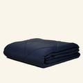 The Lightweight UltraCool Comforter folded in the navy color