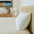 A single Avec Hybrid Pillow sitting on bed with the morning sun shining on it