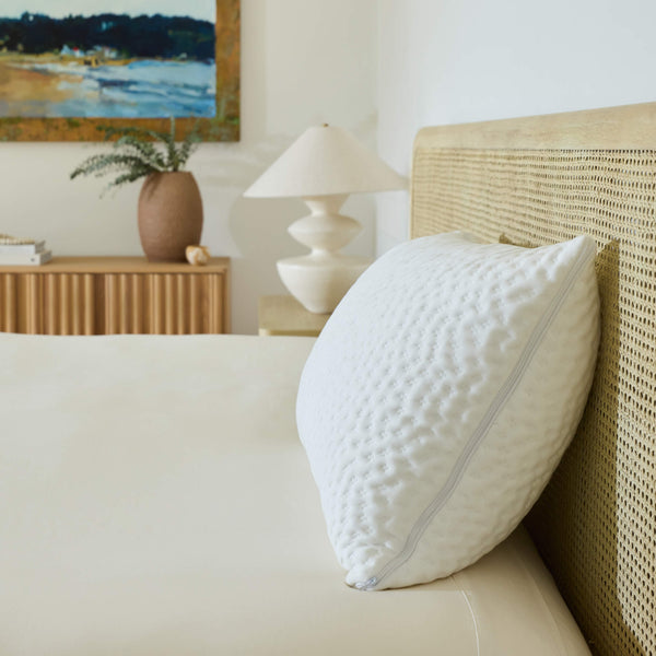A single Avec Hybrid Pillow sitting on bed with the morning sun shining on it