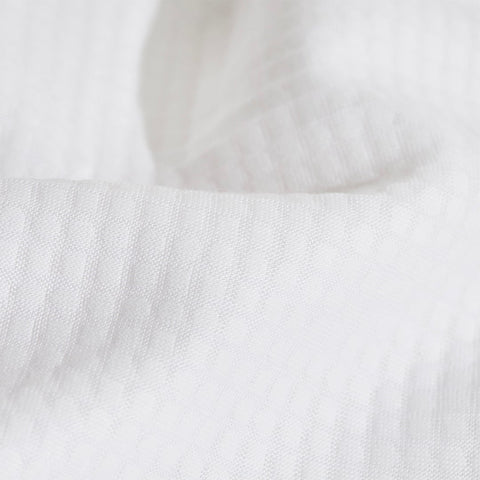A close up of the Slumber Cloud Performance Pillow Cover Set made with Outlast temperature regulation technology on a moisture wicking fabric 