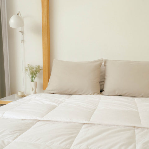 A clean bedroom with Slumber Cloud Comforter and pillows